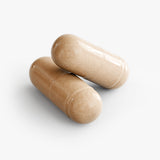 10-Mushroom Blend — close-up of two beige vegetable capsules.